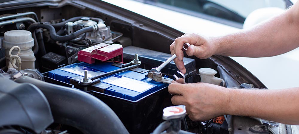 close view of mechanic installing new car battery